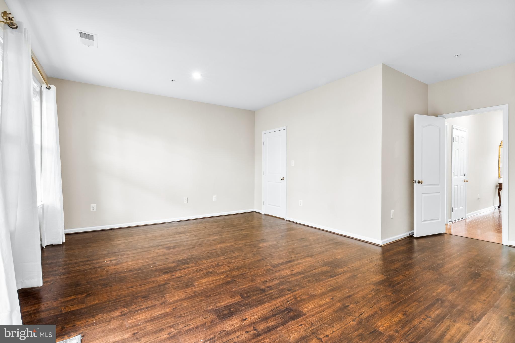 8479 Randell Ridge Road Frederick, MD 21704 - Photo 32 of 50 a view of an empty room with wooden floor and a window
