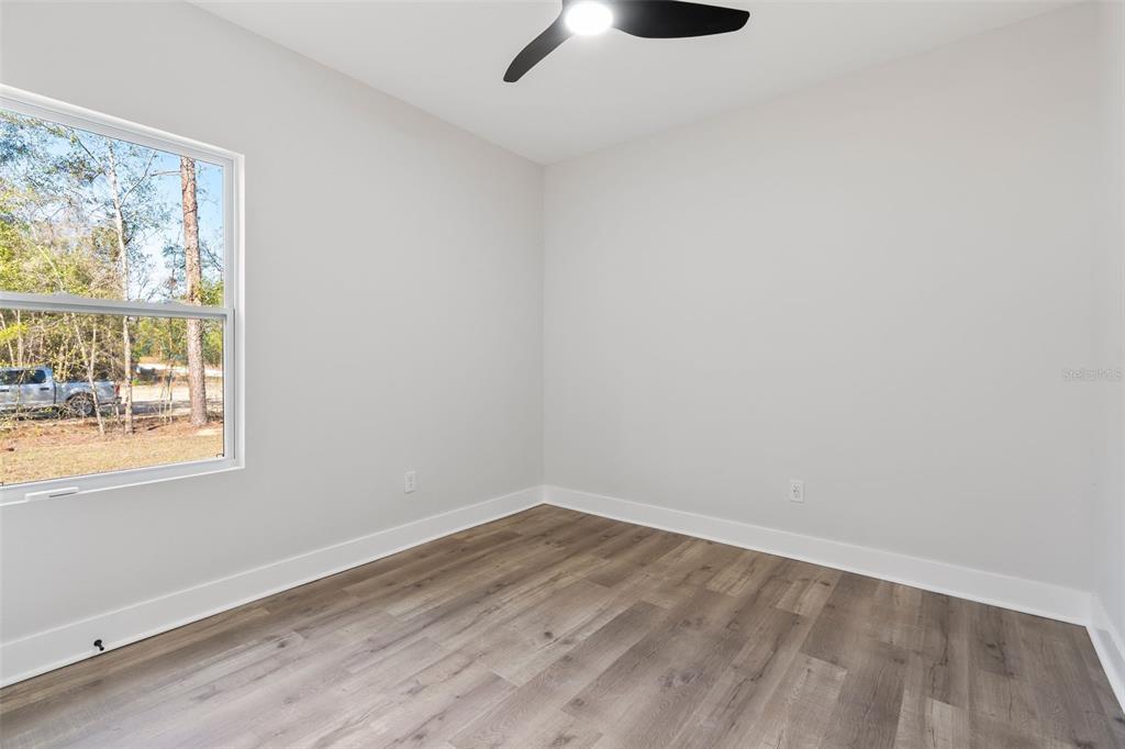 8264 Southwest 128th Terrace Dunnellon, FL 34432 - Photo 17 of 27 wooden floor in an empty room with a window