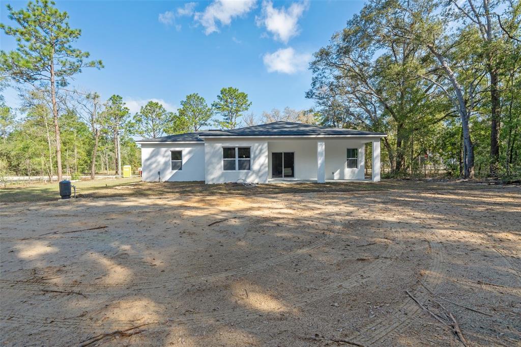 8264 Southwest 128th Terrace Dunnellon, FL 34432 - Photo 26 of 27 a view of house with yard and trees in the background