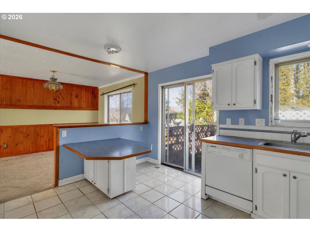 1645 Southwest 27th Street Gresham, OR 97080 - Photo 12 of 48 a kitchen with a sink cabinets and window