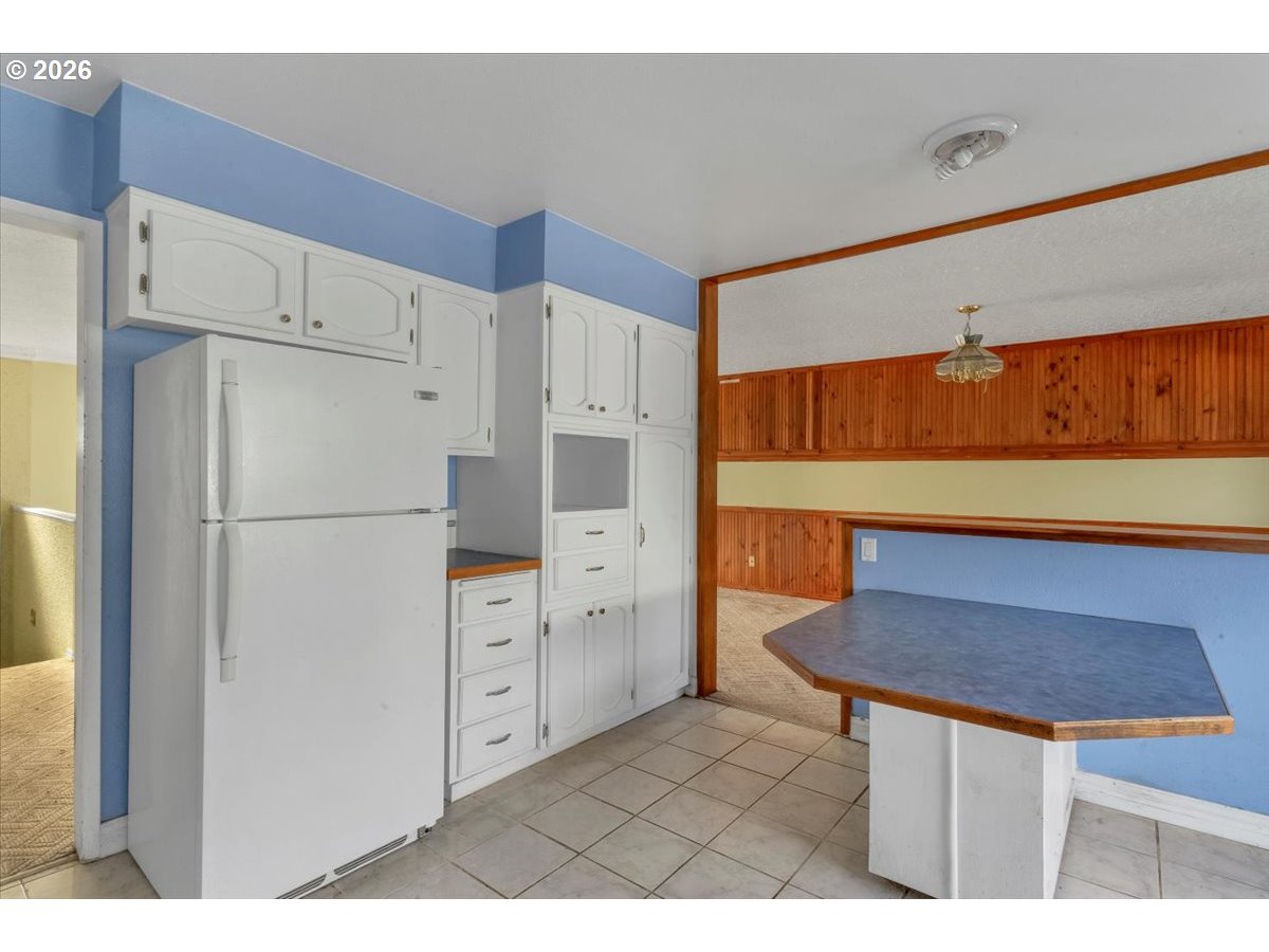 1645 Southwest 27th Street Gresham, OR 97080 - Photo 13 of 48 a kitchen with stainless steel appliances a refrigerator and a stove