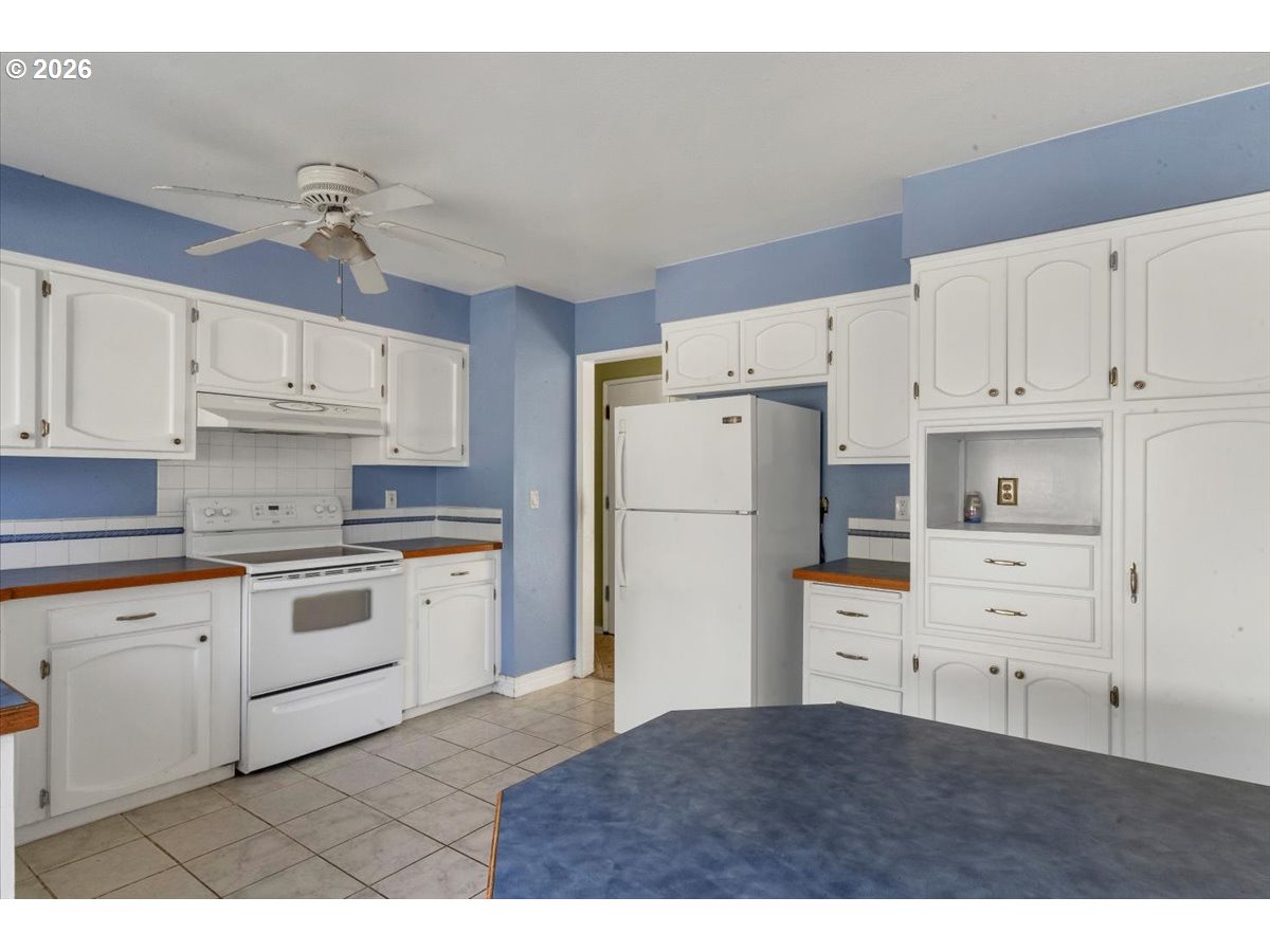 1645 Southwest 27th Street Gresham, OR 97080 - Photo 14 of 48 a kitchen with cabinets stainless steel appliances and wooden floor