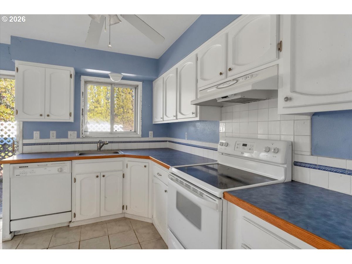 1645 Southwest 27th Street Gresham, OR 97080 - Photo 15 of 48 a kitchen with granite countertop white cabinets and a sink