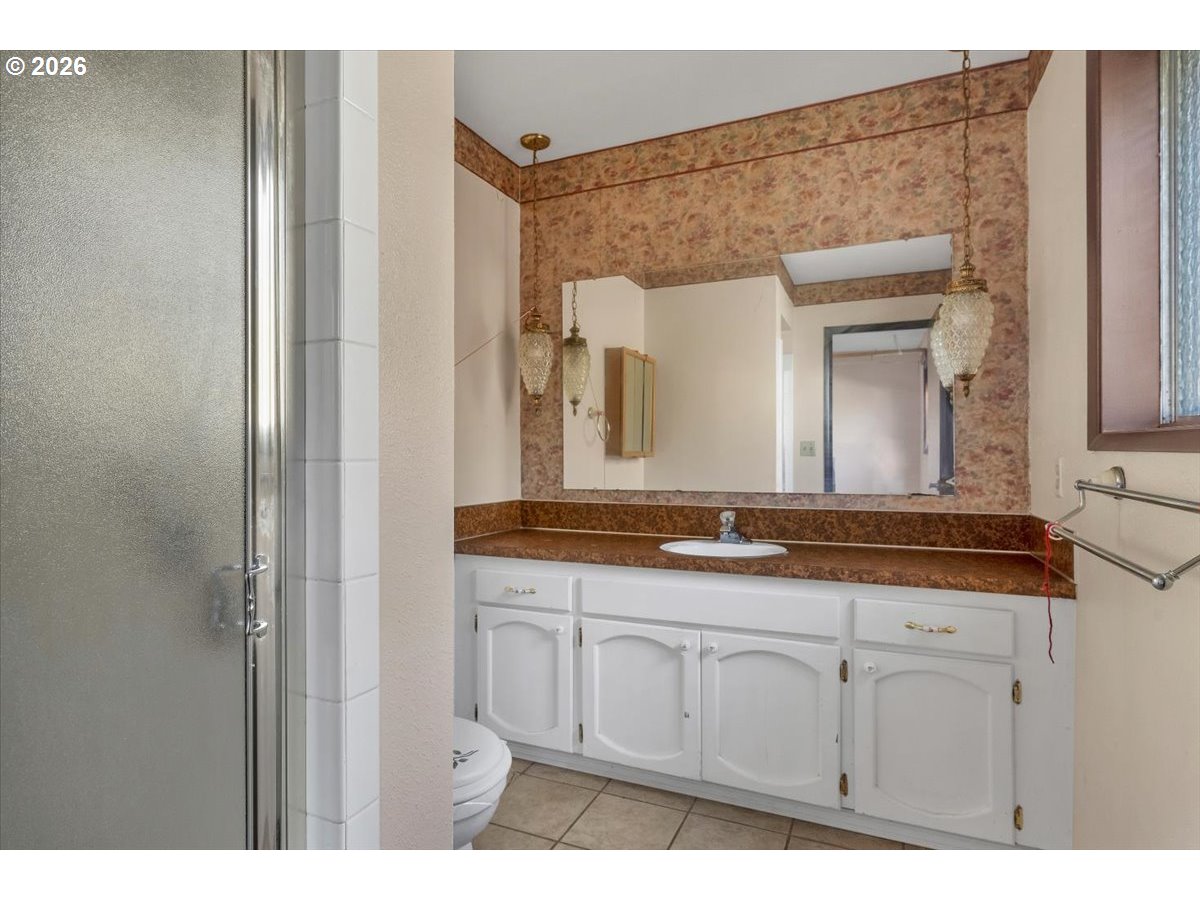 1645 Southwest 27th Street Gresham, OR 97080 - Photo 20 of 48 a bathroom with a granite countertop sink and a mirror
