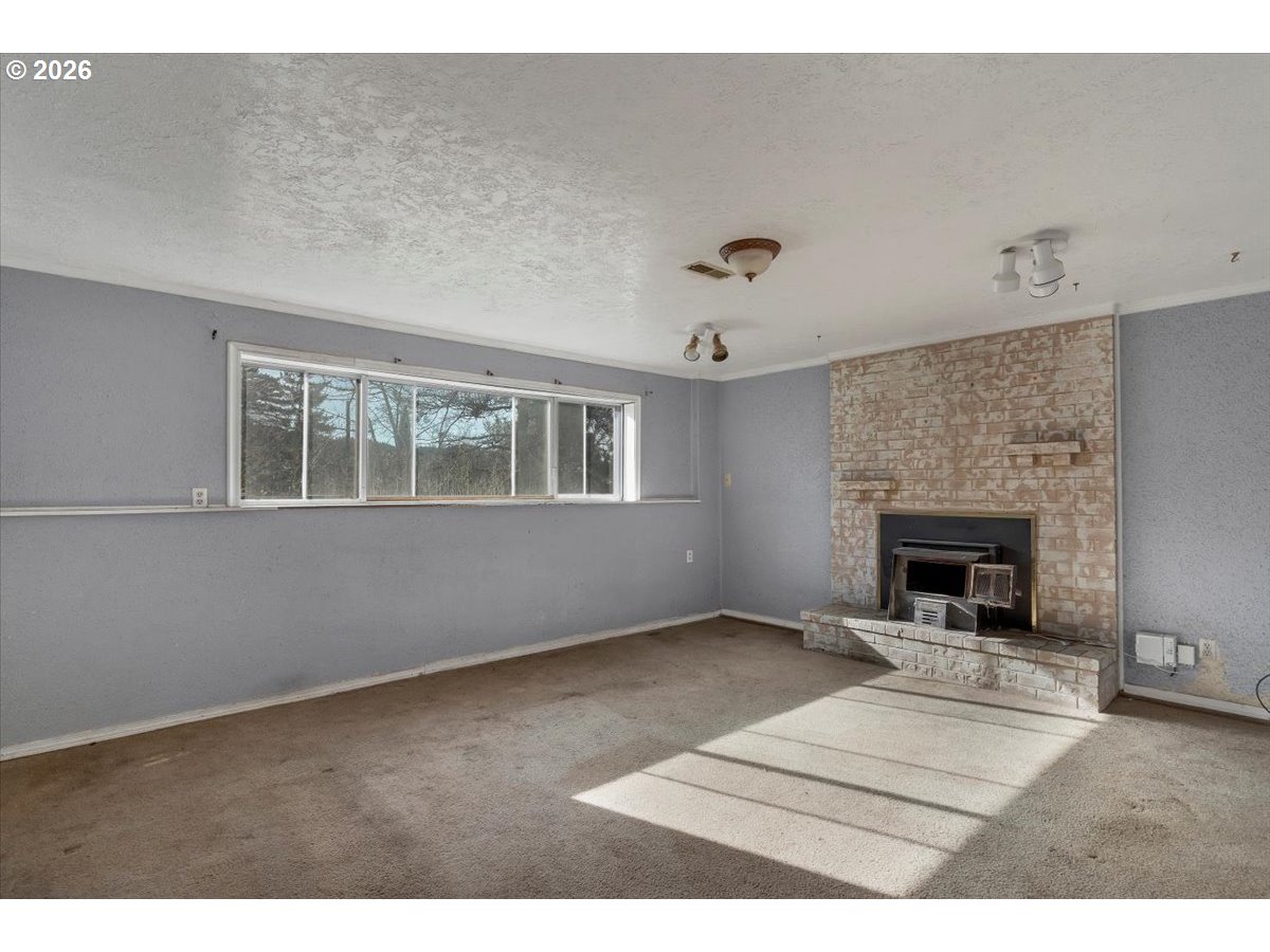 1645 Southwest 27th Street Gresham, OR 97080 - Photo 26 of 48 a view of an empty room with a window and fireplace