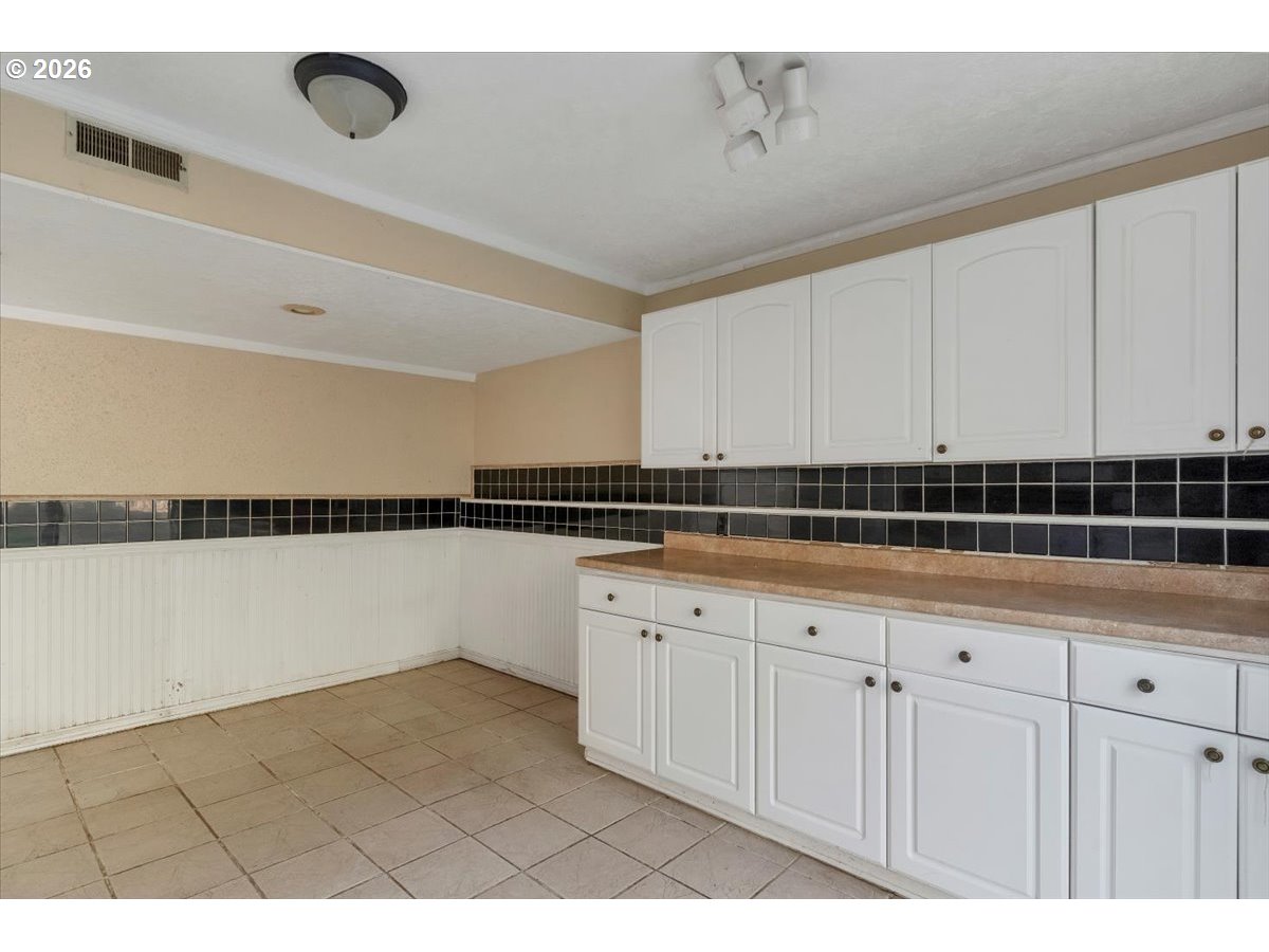 1645 Southwest 27th Street Gresham, OR 97080 - Photo 31 of 48 a kitchen with granite countertop white cabinets and a sink