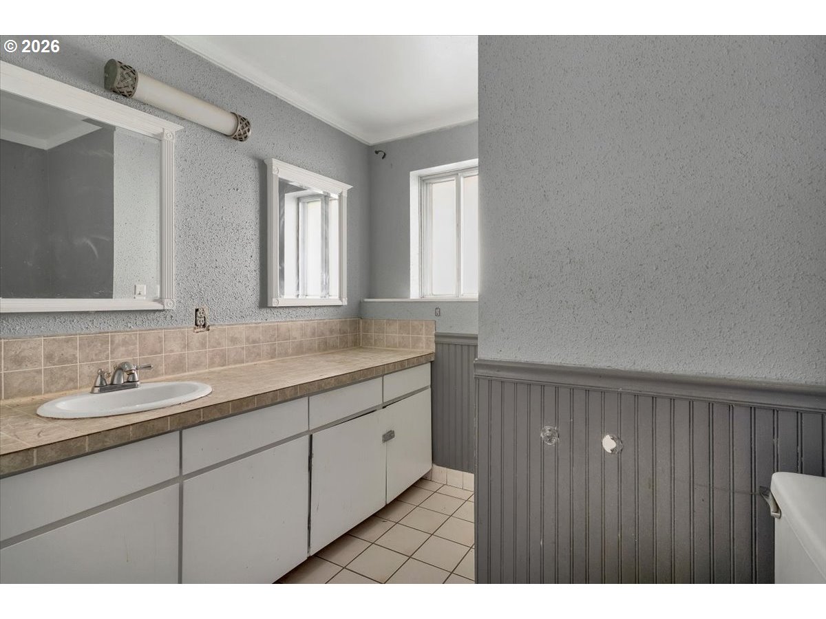 1645 Southwest 27th Street Gresham, OR 97080 - Photo 34 of 48 a bathroom with a double vanity sink and a mirror