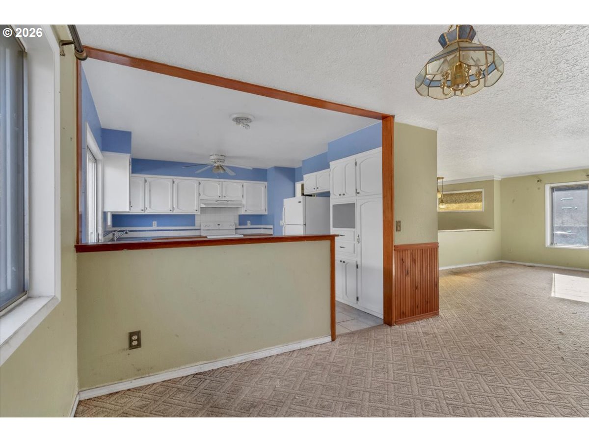 1645 Southwest 27th Street Gresham, OR 97080 - Photo 8 of 48 a view interior of kitchen and hall with wooden floor
