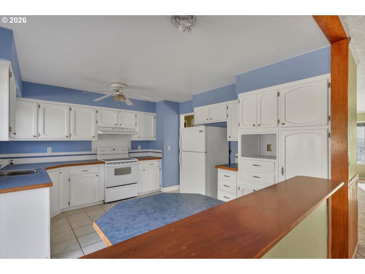 1645 Southwest 27th Street Gresham, OR 97080 - Photo 10 of 48 a kitchen with cabinets and wooden floor