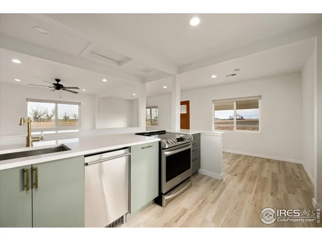 a kitchen with stainless steel appliances granite countertop a sink and a stove