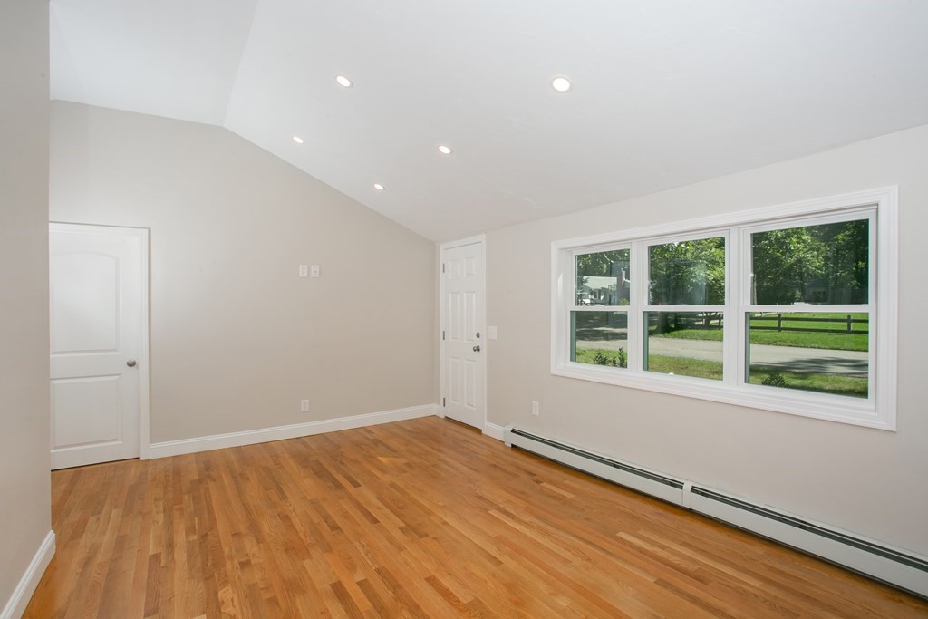 48 Madison Road Halifax, MA 02338 - Photo 6 of 12 a view of an empty room with wooden floor and a window