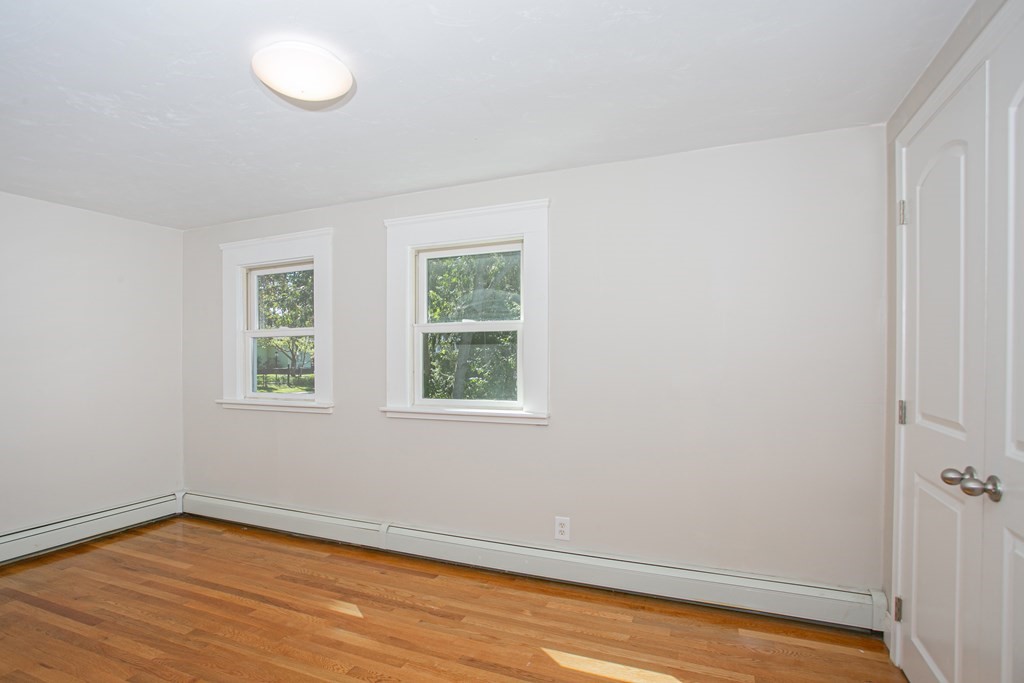 48 Madison Road Halifax, MA 02338 - Photo 9 of 12 an empty room with wooden floor and windows