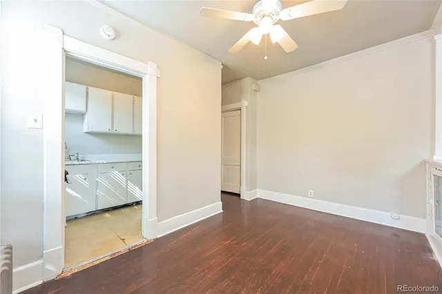 an empty room with wooden floor and door