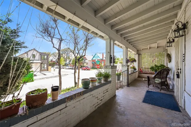 a lobby with furniture and potted plants