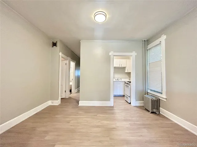 a view of a big room with wooden floor and a bathroom
