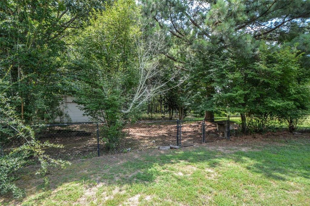 3420 Bulloch Lake Road Loganville, GA 30052 - Photo 57 of 57 a view of a bench in a garden