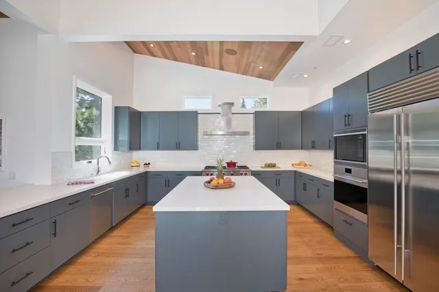 a kitchen with a refrigerator sink and wooden cabinets