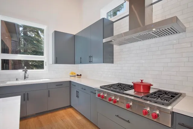 a kitchen with stainless steel appliances cabinets a sink and a stove