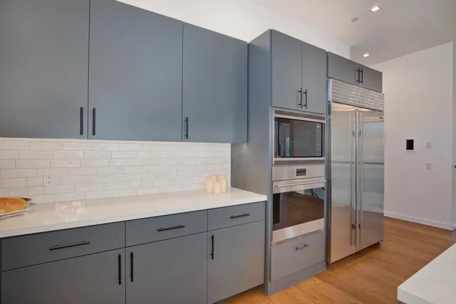 a kitchen with a sink and stainless steel appliances
