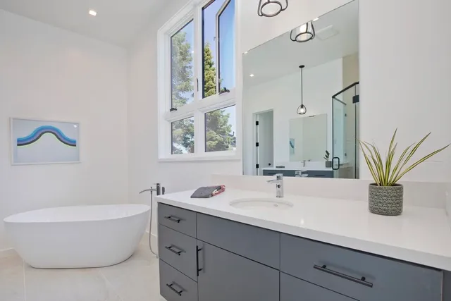 a bathroom with a double vanity sink and a bathtub