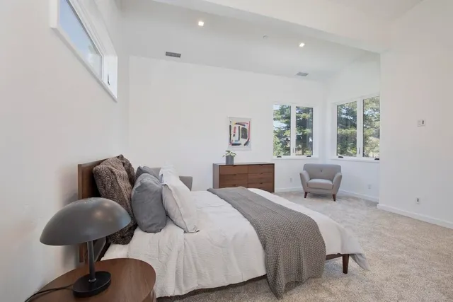 a bed room with a bed and a chair