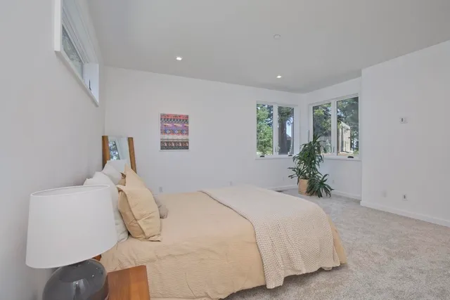 a bed room with a bed and a chair