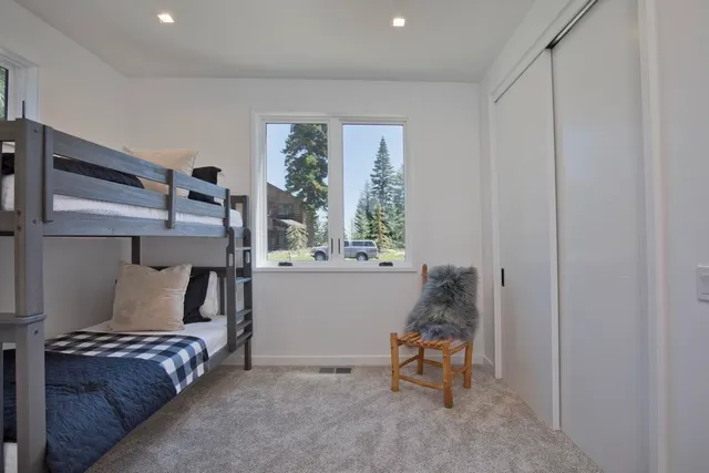 a bedroom with a bed and a window