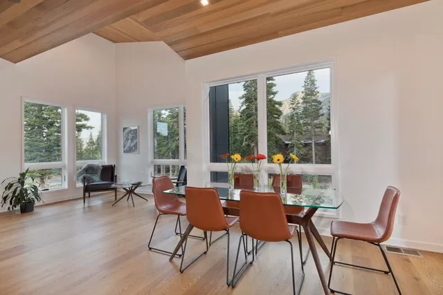 a dining room with furniture a chandelier and wooden floor