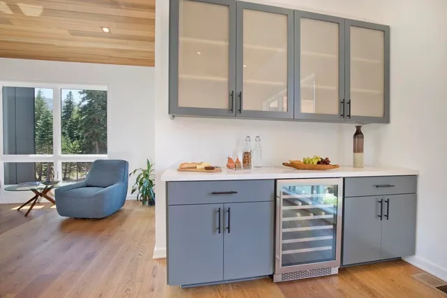 a kitchen with furniture and wooden floor