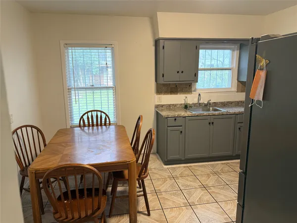 a view of a dining room with furniture and window