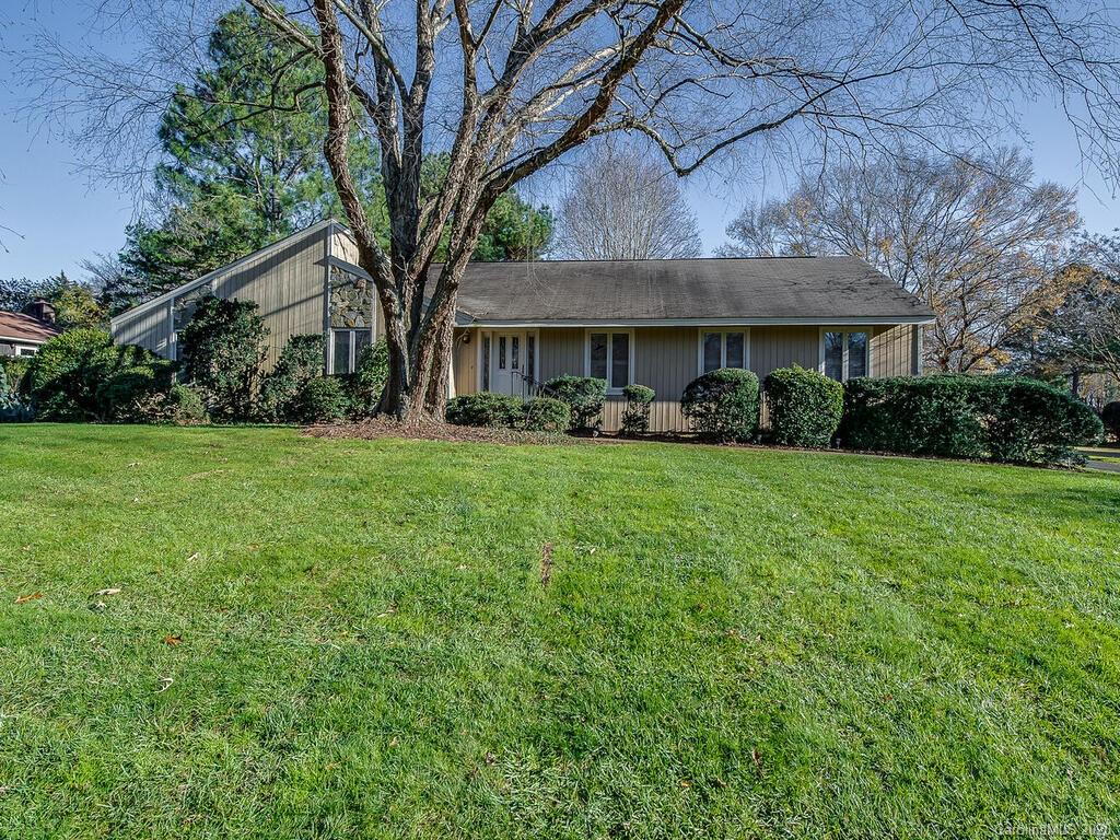 5012 Rounding Run Road Charlotte, NC 28277 - Photo 1 of 28 a front view of a house with a yard and trees