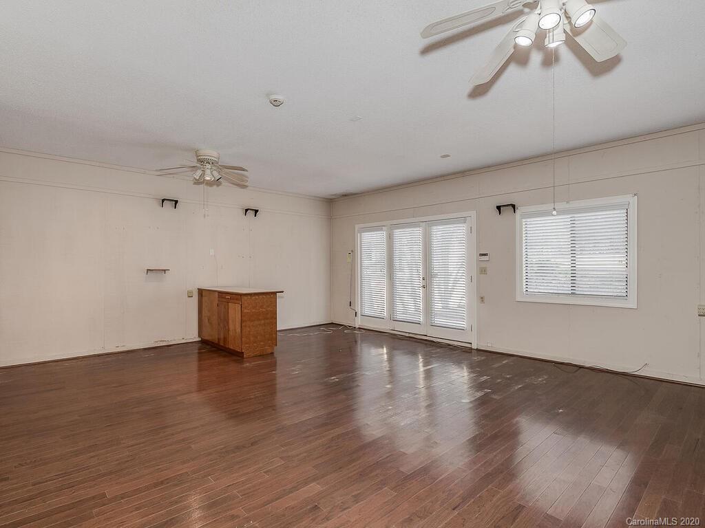 5012 Rounding Run Road Charlotte, NC 28277 - Photo 12 of 28 a view of an empty room with wooden floor and a window