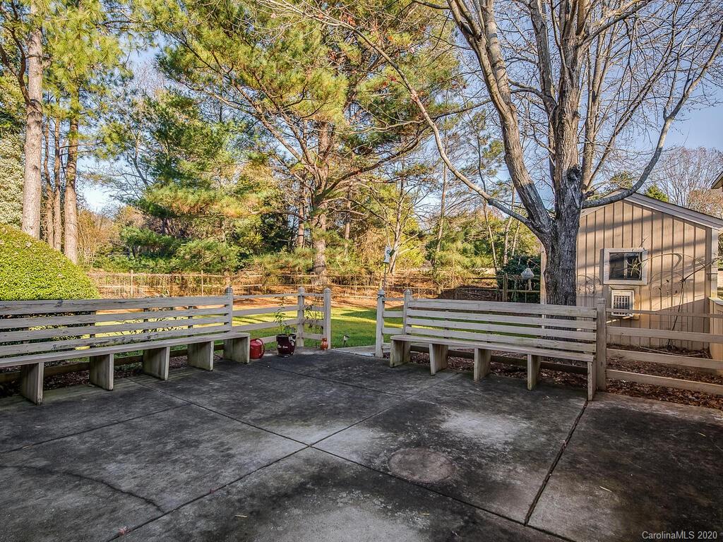 5012 Rounding Run Road Charlotte, NC 28277 - Photo 25 of 28 a backyard of a house with barbeque oven table and chairs