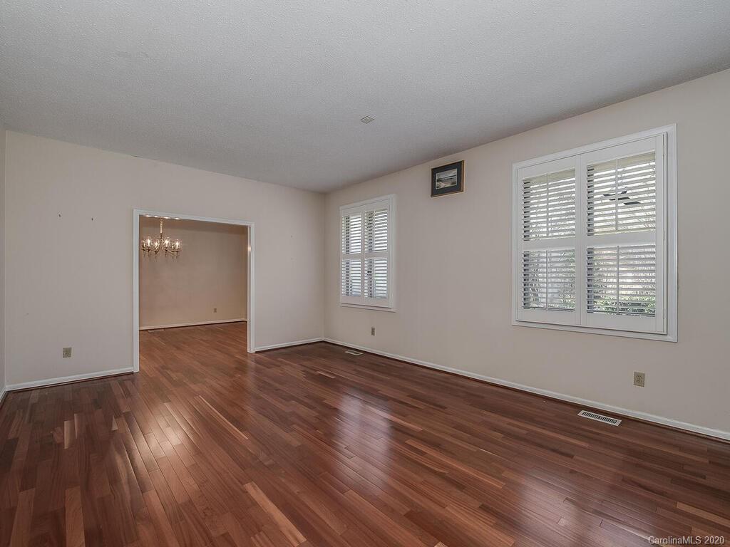 5012 Rounding Run Road Charlotte, NC 28277 - Photo 5 of 28 a view of an empty room with wooden floor and a window