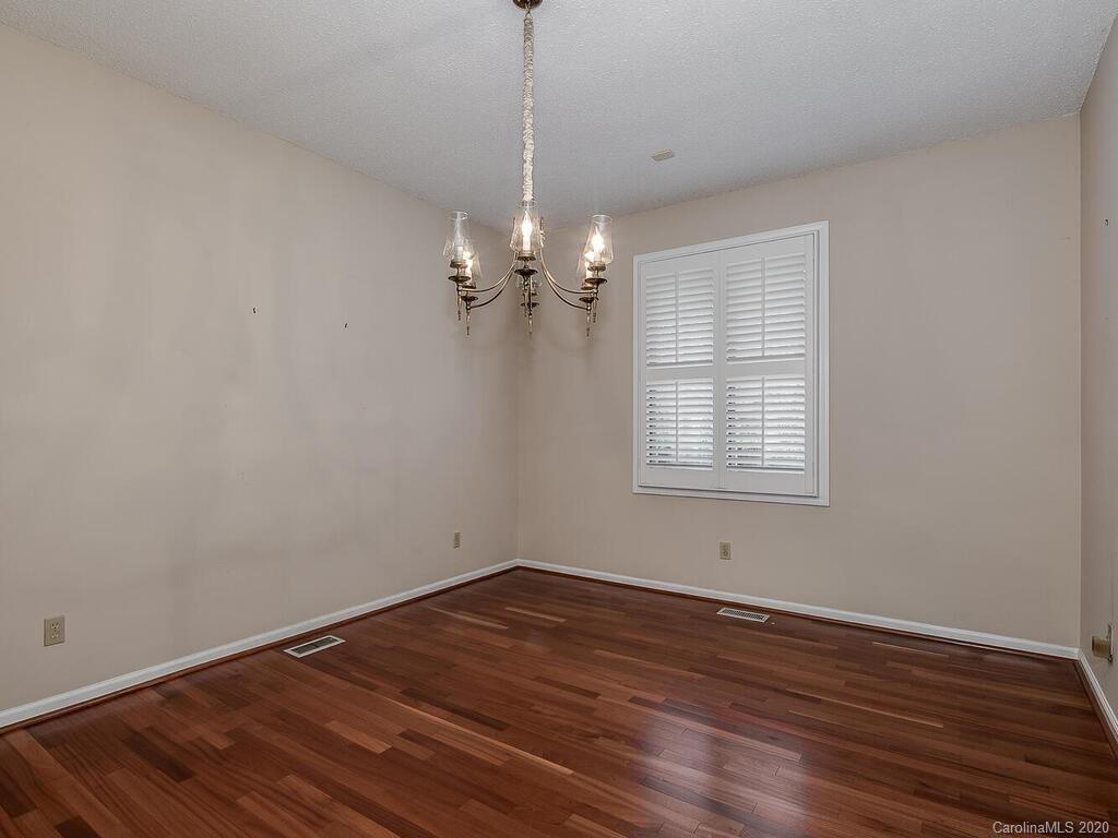 5012 Rounding Run Road Charlotte, NC 28277 - Photo 7 of 28 a view of a room with wooden floor and windows