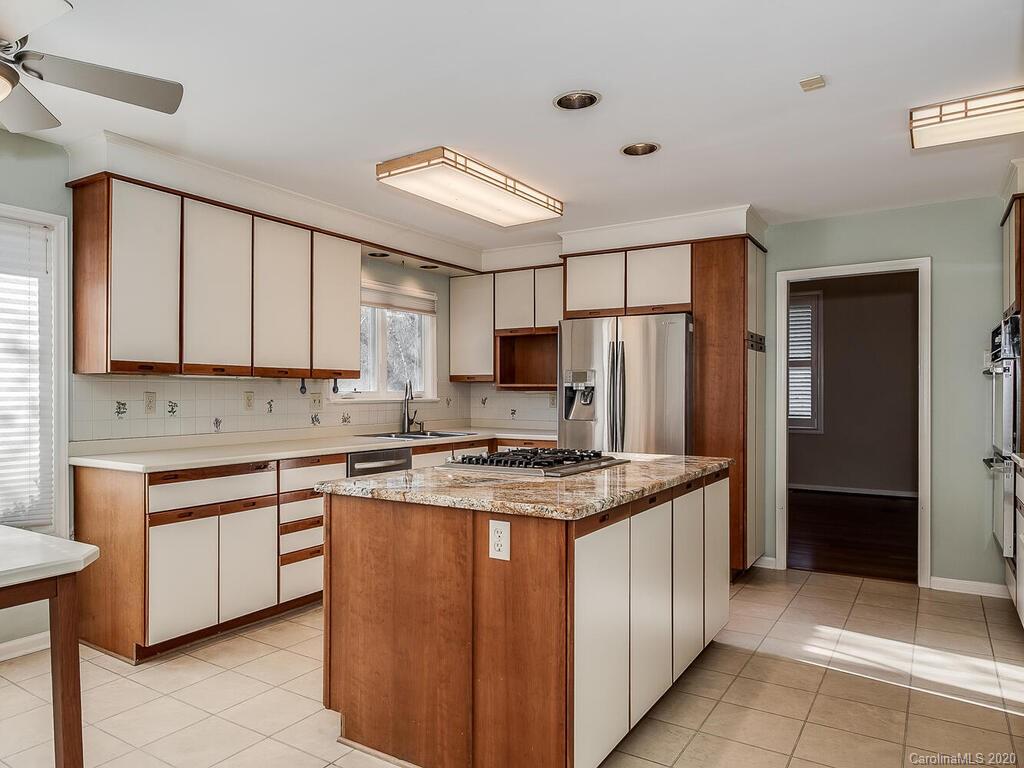 5012 Rounding Run Road Charlotte, NC 28277 - Photo 8 of 28 a kitchen with stainless steel appliances granite countertop a stove top oven a refrigerator and white cabinets