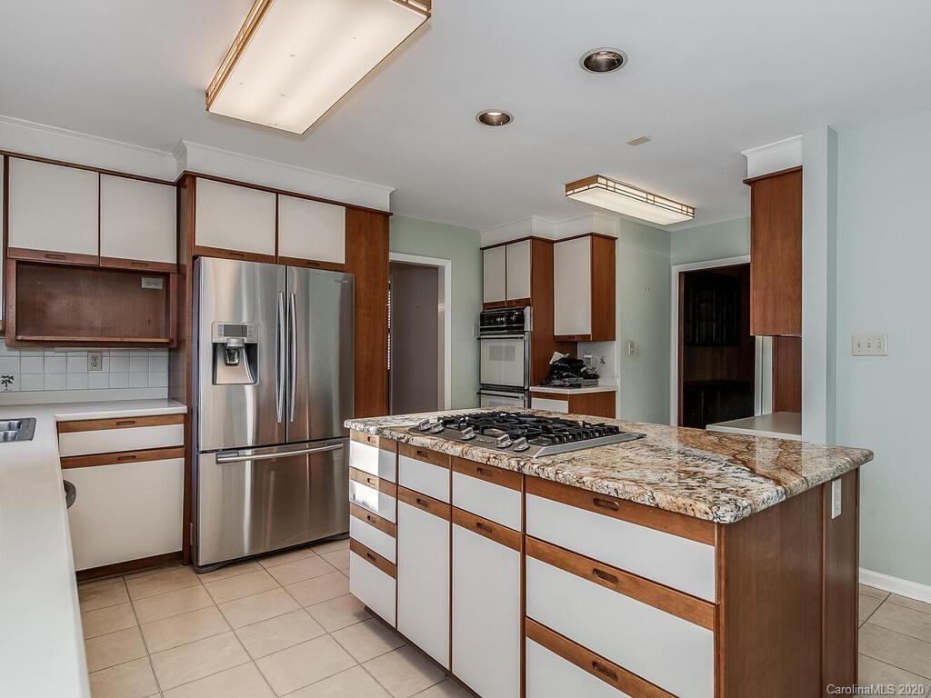 5012 Rounding Run Road Charlotte, NC 28277 - Photo 10 of 28 a kitchen with stainless steel appliances granite countertop a refrigerator and a stove top oven