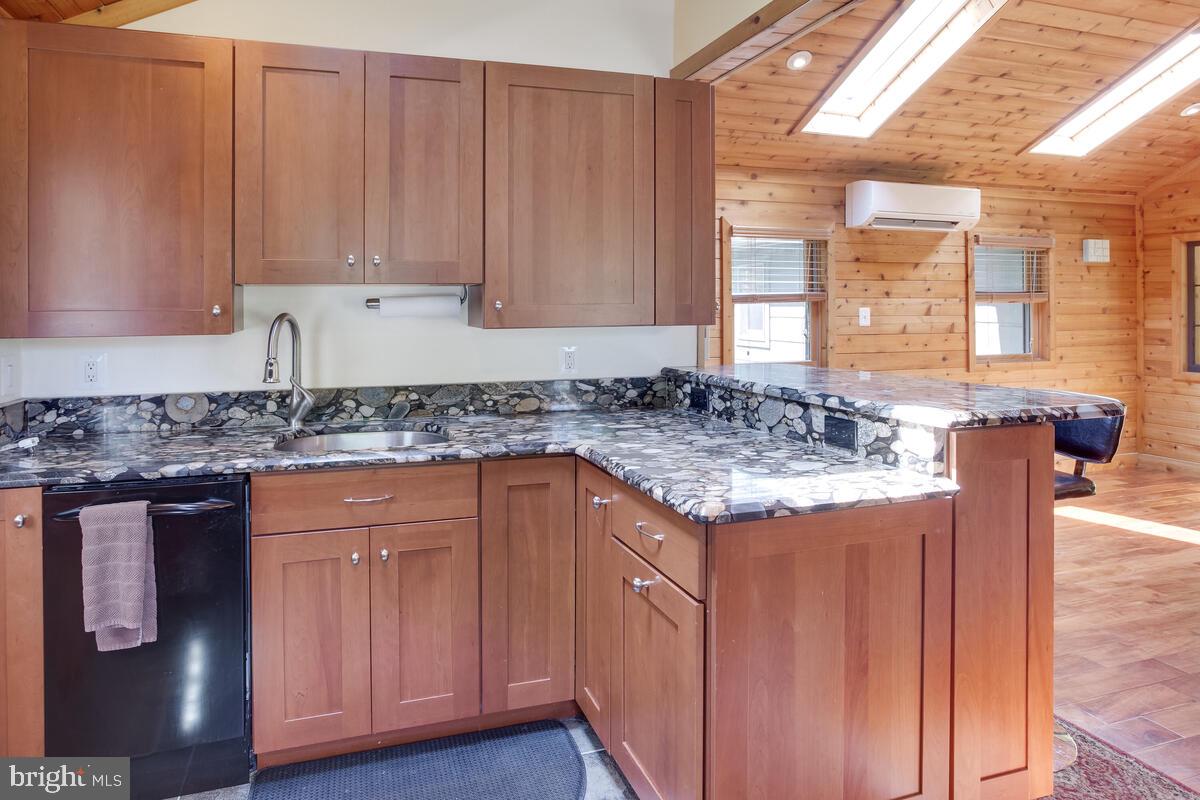 2359 Acacia Road Port Republic, MD 20676 - Photo 15 of 69 a kitchen with granite countertop wooden cabinets and a granite counter tops