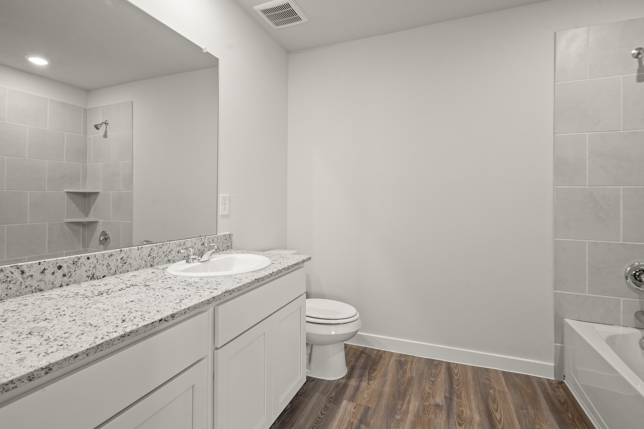 9720 Caney Bend Road Conroe, TX 77303 - Photo 16 of 24 a bathroom with a granite countertop sink a toilet and a mirror
