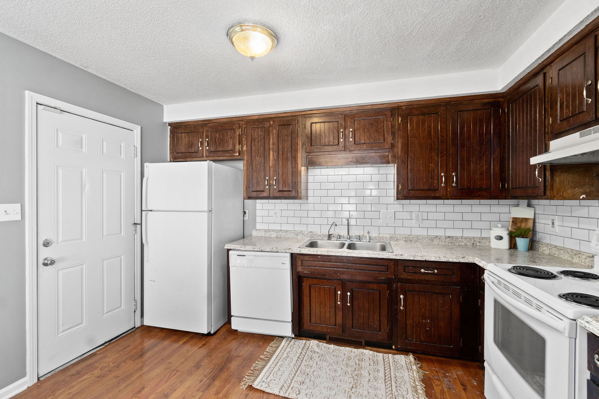 742 Needmore Road Clarksville, TN 37040 - Photo 13 of 35 a kitchen with a sink a refrigerator and cabinets