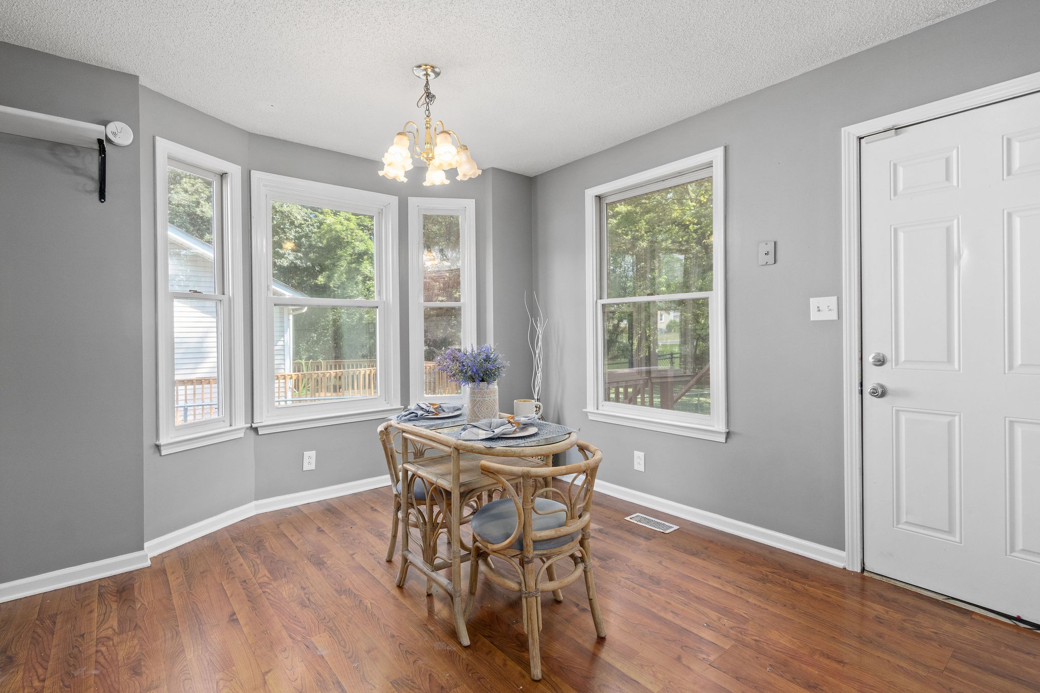 742 Needmore Road Clarksville, TN 37040 - Photo 16 of 35 a dining room with wooden floor a chandelier a glass table and chairs