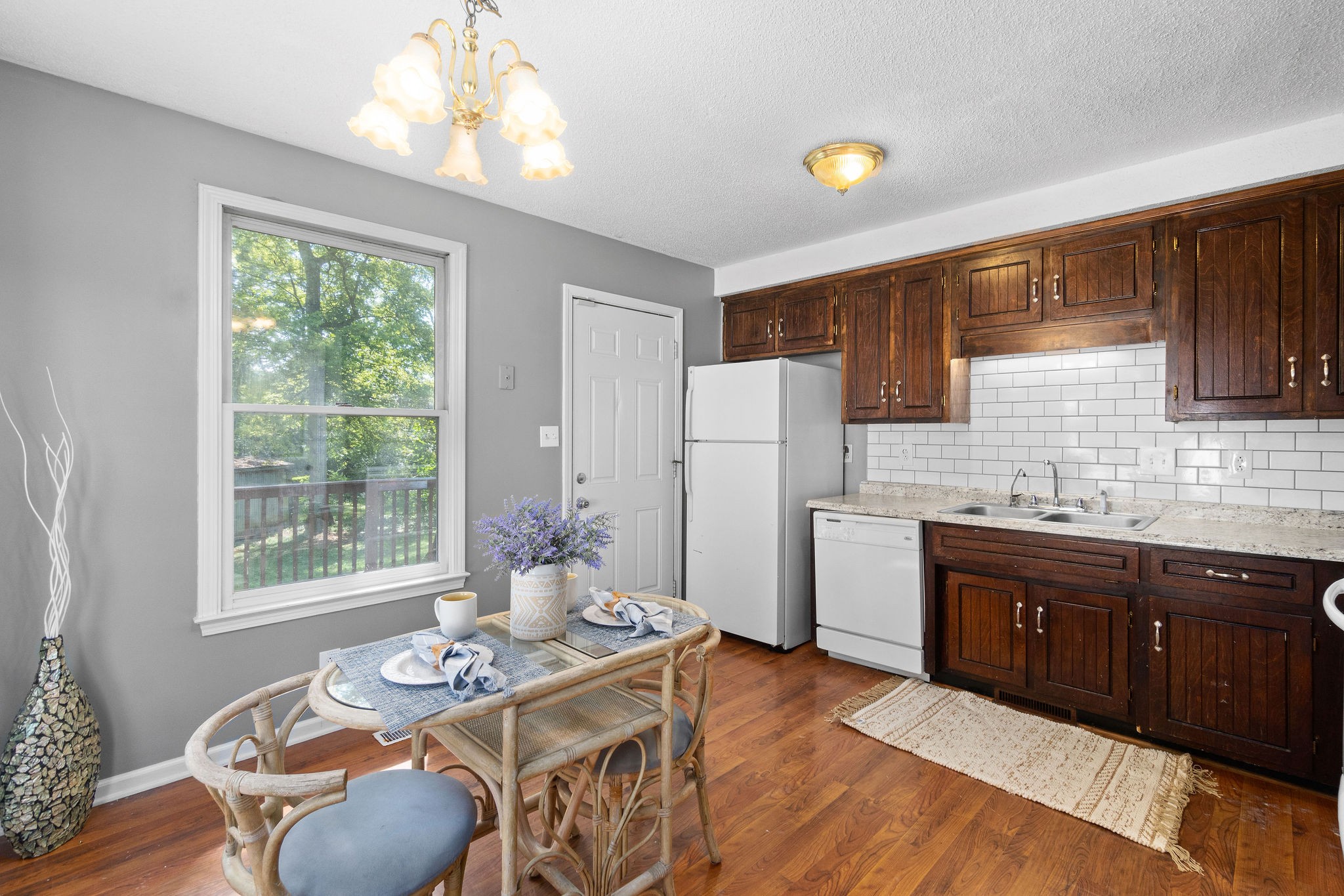 742 Needmore Road Clarksville, TN 37040 - Photo 8 of 35 a kitchen with stainless steel appliances granite countertop a refrigerator a stove a sink dishwasher with a dining table and chairs