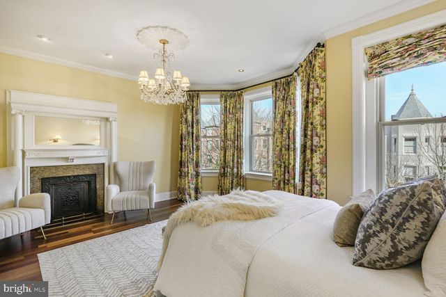 a bedroom with a bed and a fireplace