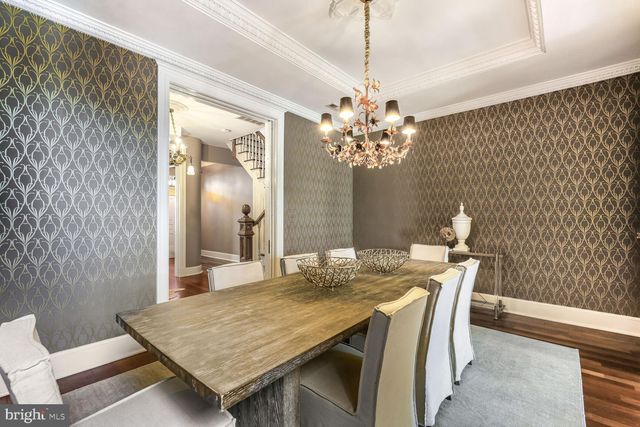 a dining room with furniture and chandelier