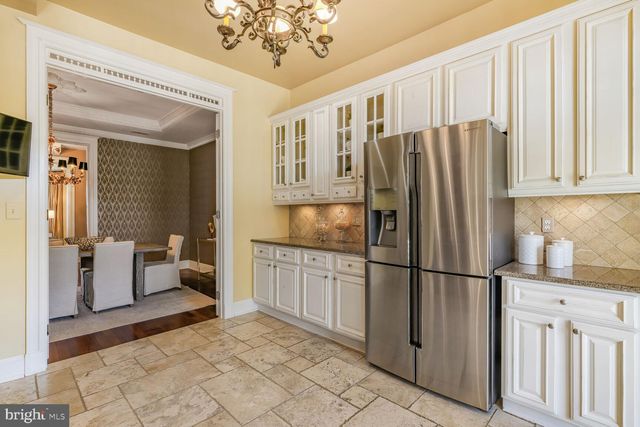 a kitchen with stainless steel appliances granite countertop a refrigerator sink and cabinets