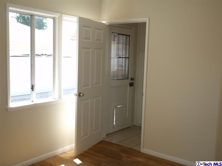 4518 Ranger Avenue El Monte, CA 91731 - Photo 11 of 20 a view of an empty room with wooden floor and a window