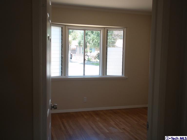 4518 Ranger Avenue El Monte, CA 91731 - Photo 17 of 20 a view of an empty room with wooden floor and a window