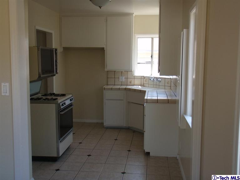 4518 Ranger Avenue El Monte, CA 91731 - Photo 5 of 20 a kitchen with a sink stove and refrigerator