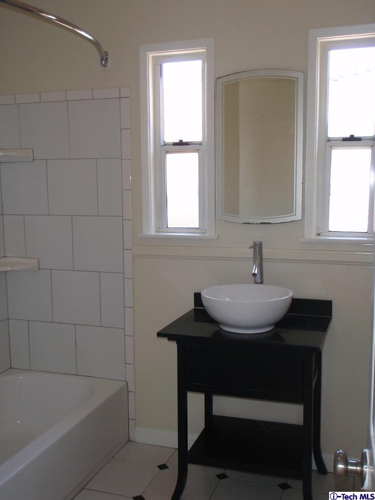 4518 Ranger Avenue El Monte, CA 91731 - Photo 7 of 20 a bathroom with a sink and a bathtub