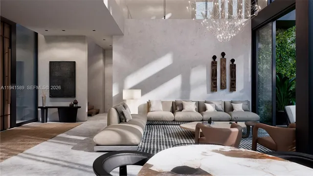 a living room with furniture and a chandelier